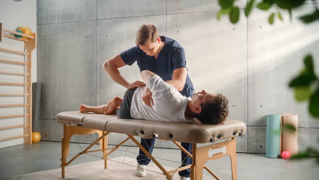 Physiotherapist providing home exercise therapy to an elderly patient in Pune